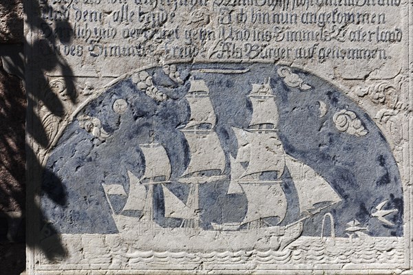 Historical grave slab with sailing ship and inscription
