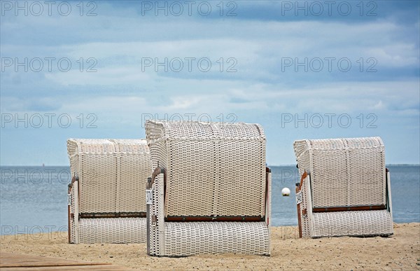Three white beach chairs