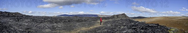 Woman looking over lava field of Krafla volcano system