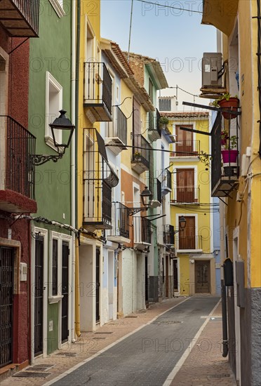 Narrow street with colorful houses in seaside town of Villajoyosa