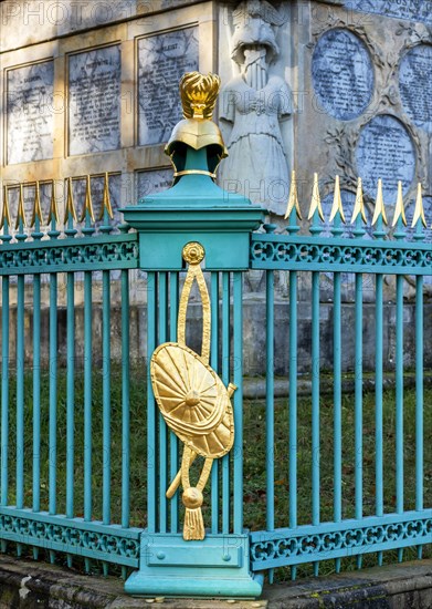 Restored fence with gold helmets at the Lake Grienerick obelisk in Rheinsberg