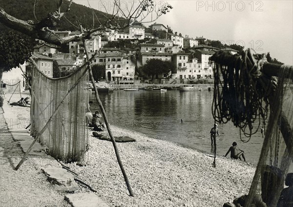Yugoslavia in 1959: Moscenicka Draga beach with suspended fishing nets