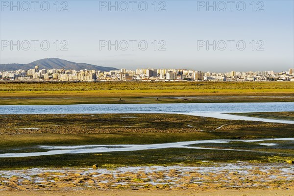 City of Faro seen from Faro Beach Peninsula with wetlands of Ria Formosa in between