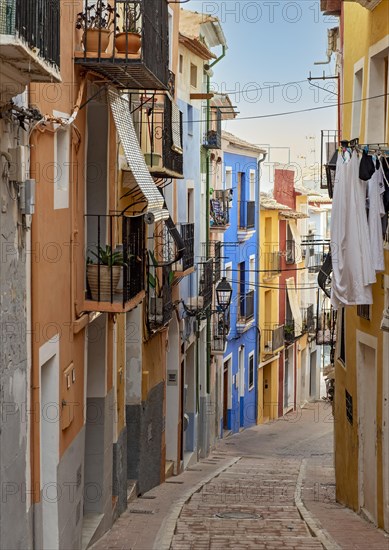 Narrow street with colorful houses in seaside town of Villajoyosa