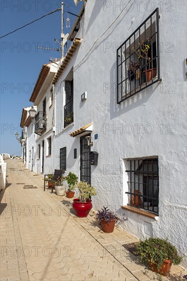 Colorful flowerpots outside white houses of Altea Old Town