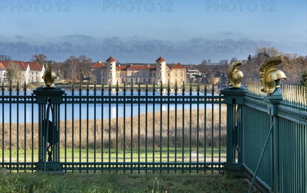 Restored fence with gold helmets at the Lake Grienerick obelisk in Rheinsberg