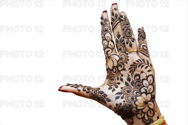 Hand of Hindu bride painted with hennas isolated on white background