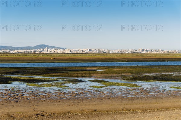 City of Faro seen from Faro Beach Peninsula with wetlands of Ria Formosa in between