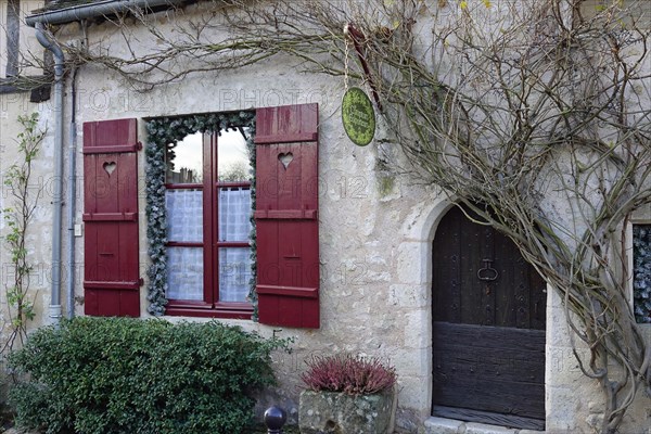 House entrance and window with red shutters