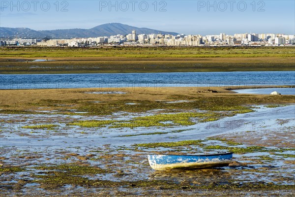 Boat by Ria Formosa wetlands during low tide