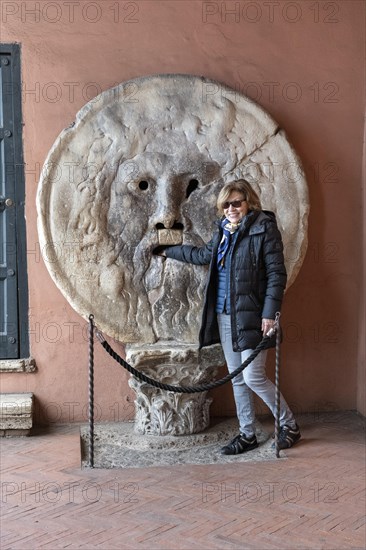 Western tourist puts hand in mouth of truth