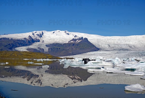 Icebergs and glaciers reflected in a lake