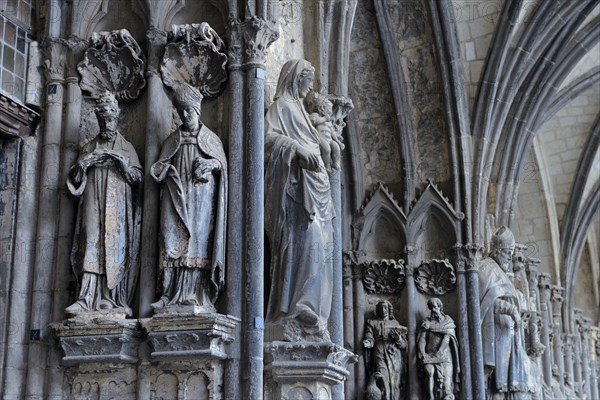 Old sculptures in need of renovation at the entrance gate to Notre-Dame Cathedral in Tournai