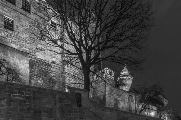 Illuminated Sinwell Tower with Kaiserburg Castle in the Evening