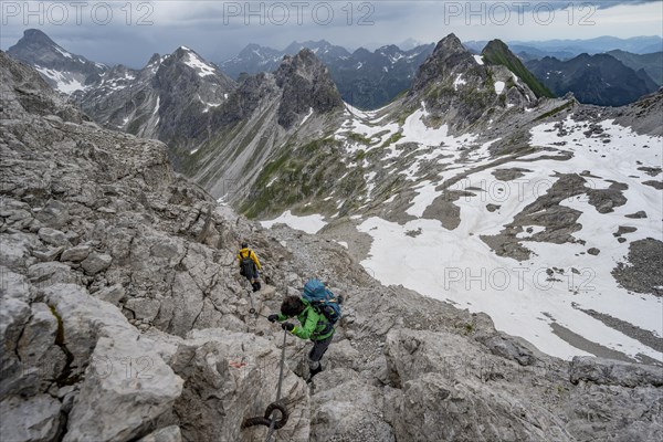 Hiker and hiker descending rocky terrain