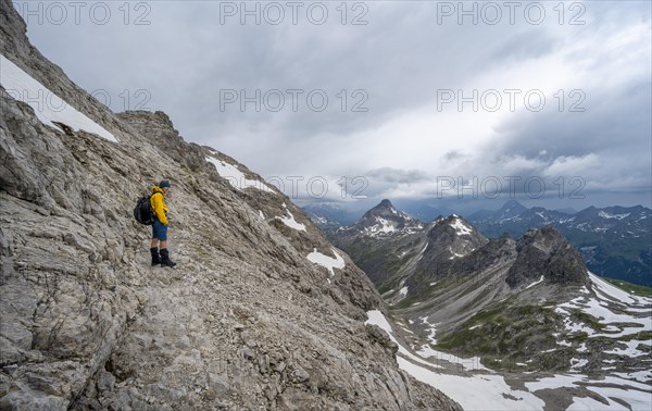 Hiker on hiking trail in rocky terrain