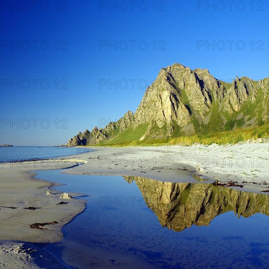 Mountains reflected in a small body of water