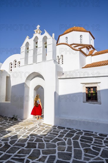 Young woman with red dress in walks into an aisle