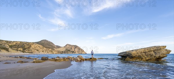 Young man standing on a rock