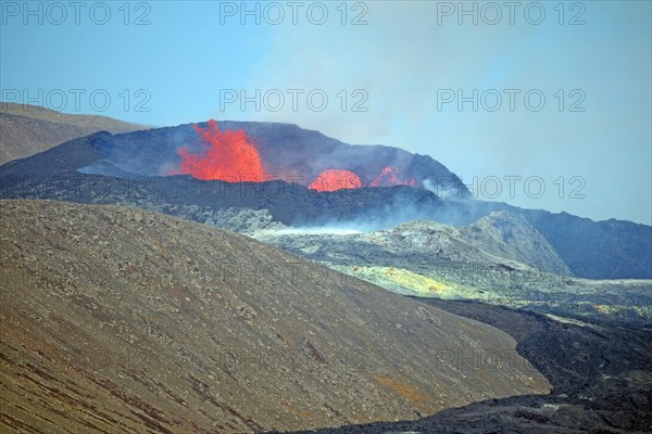 Sulphur fields and lava fields in front of volcanic craters