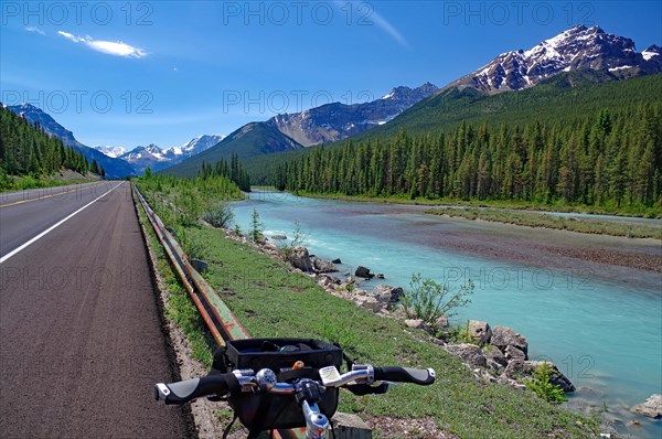 Bicycle handlebars in front of endless road