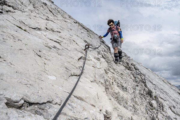 Hiker descending rocky terrain