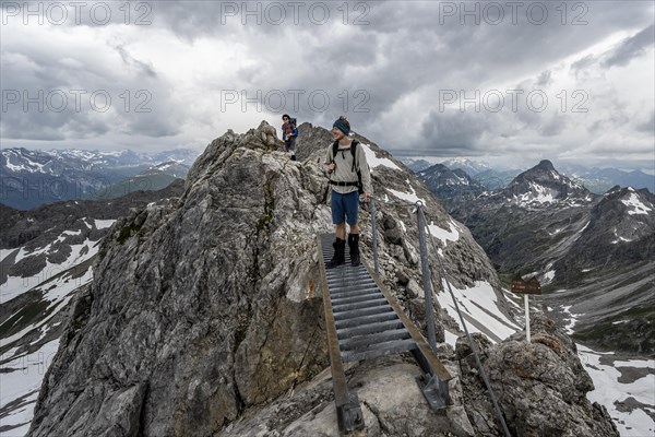 Hiker on a metal bridge on a rock