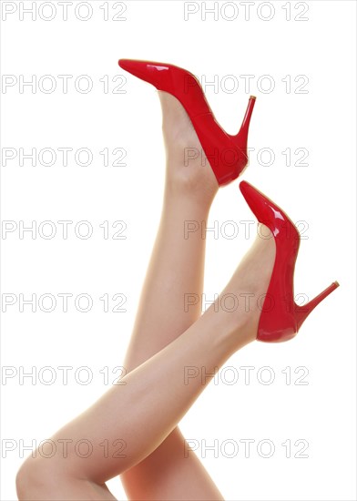 Womans legs with red stiletto high heel shoes