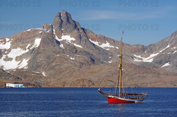 Sailing ship Dagmar Aaen in front of barren mountains