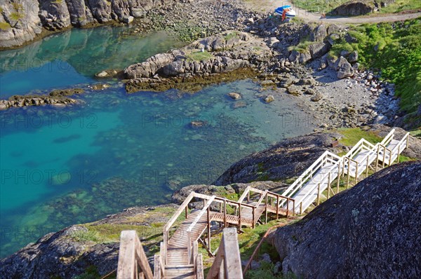 Long wooden stairs leading down to a bay