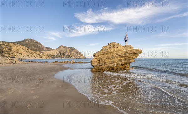 Young man standing on a rock