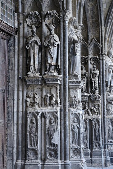 Old sculptures in need of renovation at the entrance gate to Notre-Dame Cathedral in Tournai