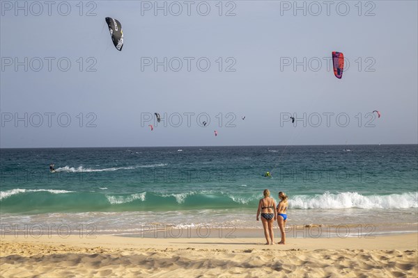 Two tourists looking at the sea