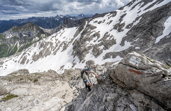 Hikers descending rocky terrain