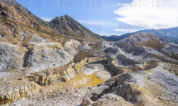 Crater with yellow discoloured sulphur stones and colourful mineral deposits
