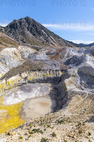 Crater with yellow discoloured sulphur stones and colourful mineral deposits
