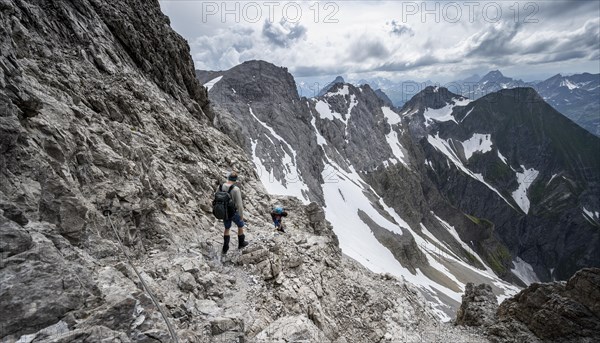 Hiker and woman descending rocky terrain