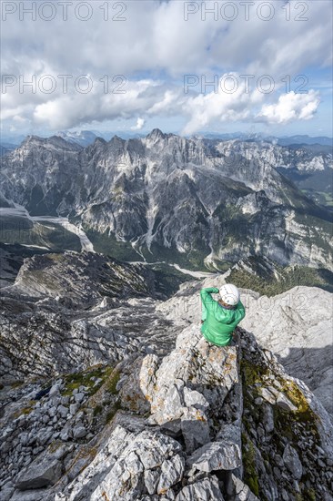 Hiker with helmet at the summit of the Watzmann