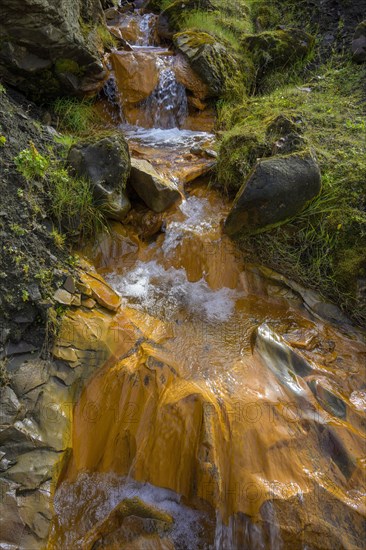 Stream coloured orange by iron oxide