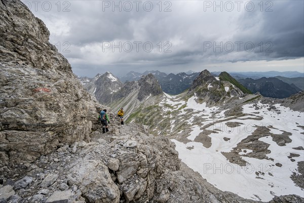 Hiker and hiker descending rocky terrain