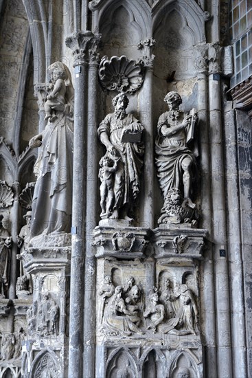 Old sculptures in need of renovation at the entrance gate to Notre-Dame Cathedral in Tournai