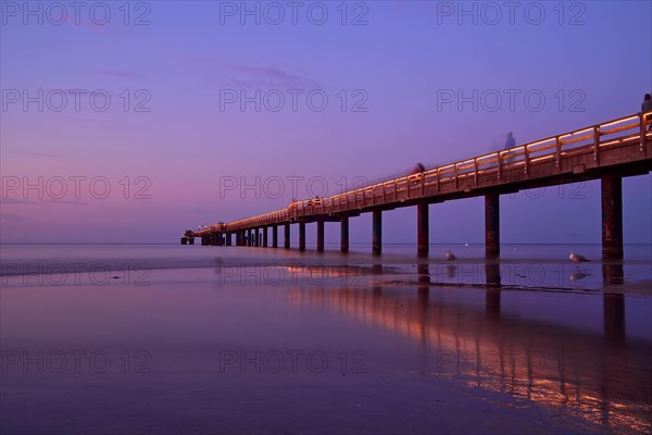 Pier illuminated in the sunset