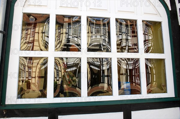 Windows with bull's eye panes in historic half-timbered house