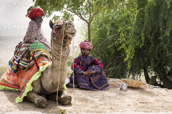 Men of the Dhebariya Rabari community in traditional dress with a dromedary