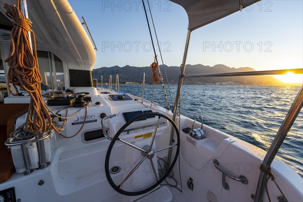 Steering wheel in the cockpit on deck of a sailing catamaran