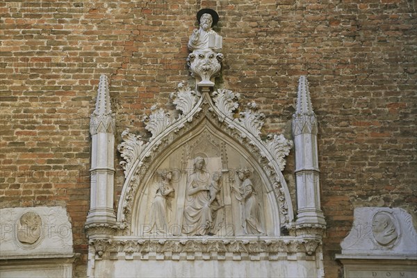 Relief above a side portal of the Basilica Santa Maria Gloriosa dei Frari