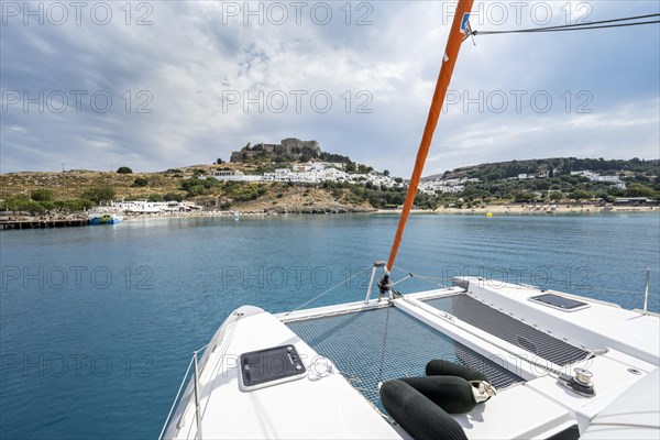 Deck of a sailing catamaran with net and fenders