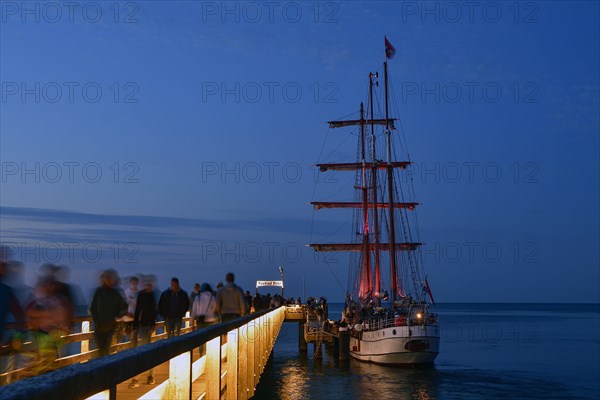 Evening atmosphere jetty with moored three-master sailing boat