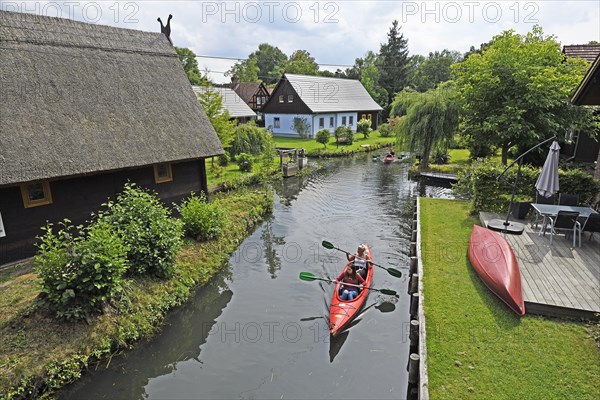 Tourists paddle through the village of Lehde