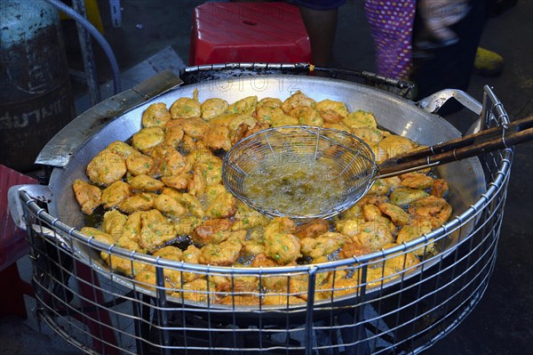 Fish cakes being deep fried